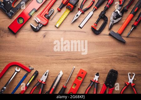 Assorted work tools on wooden background Stock Photo