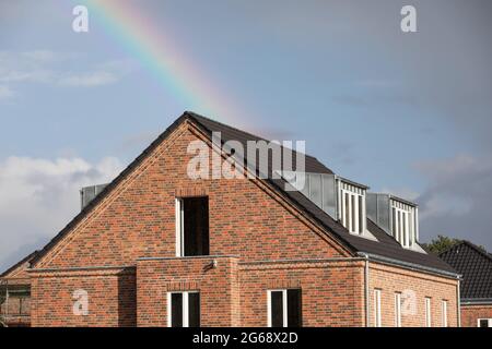 rainbow over new brick house Stock Photo