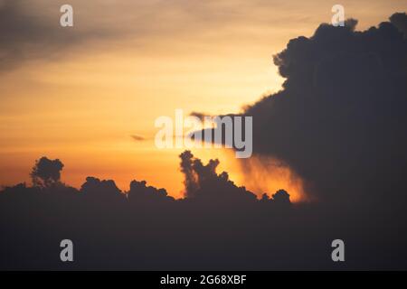 Giant dark cloud. Storm Clouds at Sunset before rain abstract weather environment season. Stock Photo