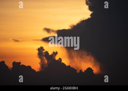 Giant dark cloud. Storm Clouds at Sunset before rain abstract weather environment season. Stock Photo