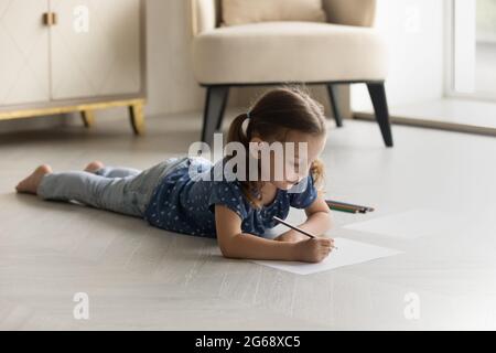 Adorable little girl kid drawing with colorful pencils on floor Stock Photo