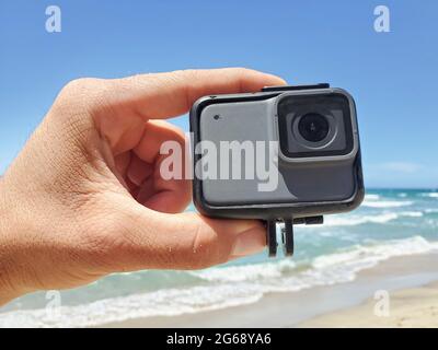 Man hand while holding action water resistent camera before filming sport session,tech devices Stock Photo