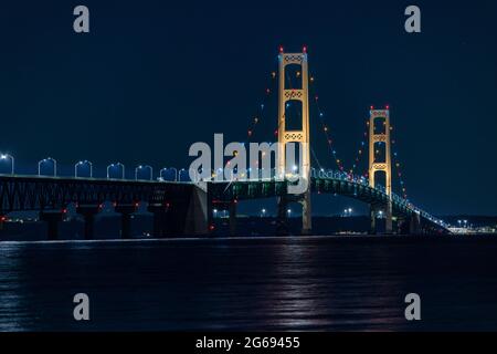 Mackinac Bridge at night. Opened in 1957, the 5 mile-long Mackinac Bridge is the world's 20th-longest main span and the longest suspension bridge betw Stock Photo