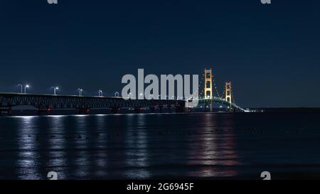 Mackinac Bridge at night. Opened in 1957, the 5 mile-long Mackinac Bridge is the world's 20th-longest main span and the longest suspension bridge betw Stock Photo