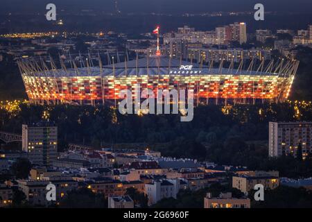 Warsaw, Poland - June 18, 2021: National Stadium (Polish: Stadion Narodowy, PGE Narodowy) illuminated at night, city landmark. Stock Photo