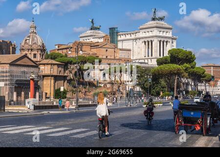 Rome, Lazio, Italy - August 27, 2020: People on Via dei Fori Imperiali street and Altar of the Fatherland in historic city center. Stock Photo