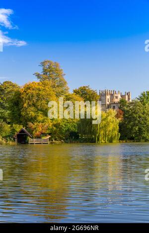 The view across the ornamental lake created by Capability Brown towards Sherborne Castle, Dorset, England, UK