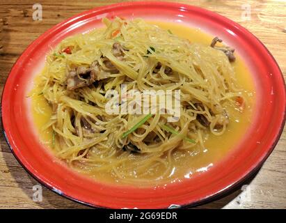 fresh shredded potatoes on the red plate ready for eating Stock Photo