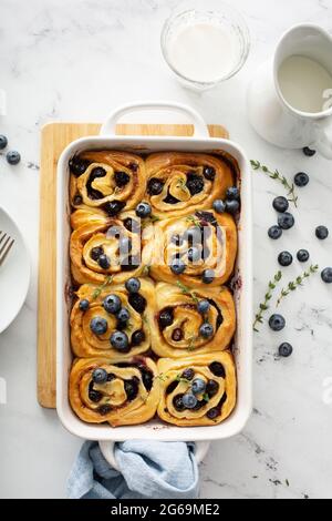 Summer breakfast idea, blueberry cinnamon rolls in a baking dish Stock Photo