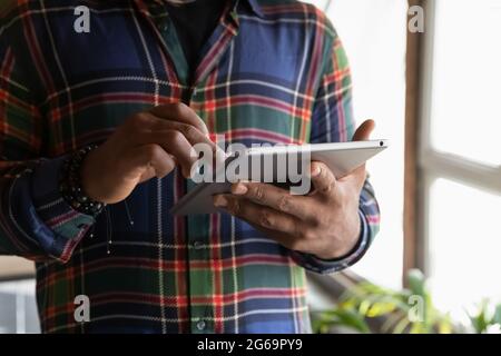 Close up cropped of African American man using modern tablet Stock Photo