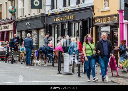 Kenmare, Co. Kerry, Ireland. 4th July, 2021. The Co. Kerry town of Kenmare was very busy today, with many people eating outside as COVID-19 restrictions forbid people to eat indoors. A few people wore facemasks, but most tourists were mask-free. Credit: AG News/Alamy Live News Stock Photo