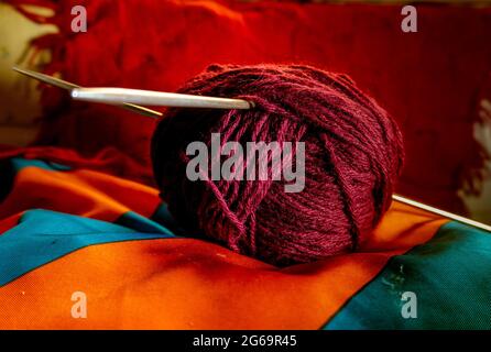 maroon wool yarn ball for needle knitting Stock Photo