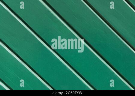 Green wood background. Striped Wooden boards painted with green paint Stock Photo