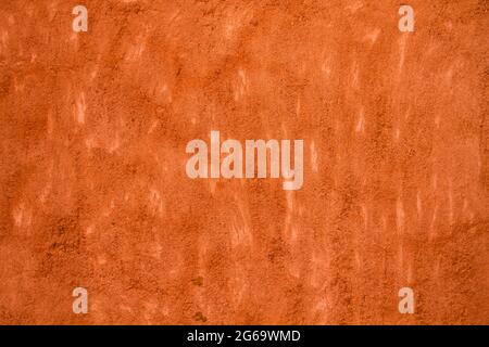 Terracotta colored concrete wall grunge background or texture Stock Photo