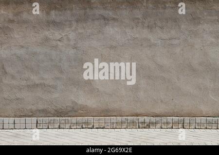 Old concrete wall with tiled baseboard, urban background grunge texture Stock Photo