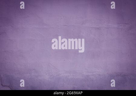 Violet plaster wall with dark vignette borders, grunge background or texture Stock Photo