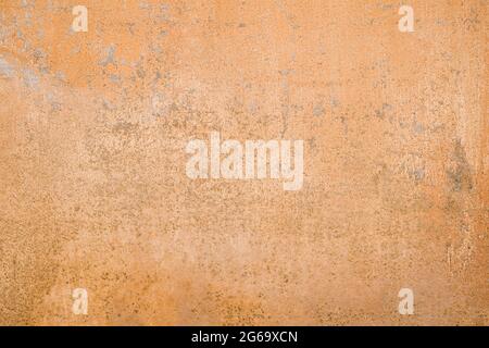 Old wall with peeling paint, peach color grunge background or texture Stock Photo