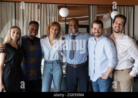 Portrait of smiling diverse employees colleagues team standing in office Stock Photo