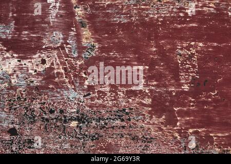 Old corroded metal with worn out red peeling paint, grunge background or texture Stock Photo