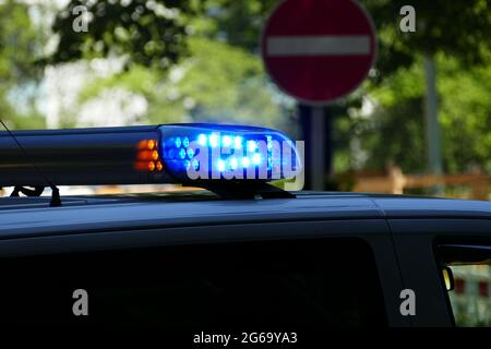 Close-up of activated blue LED warning lights on a German police car, flashing during an emergency response operation in Munich, Germany. Stock Photo