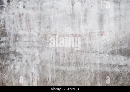 Concrete wall with white dripping paint, grunge background or texture Stock Photo