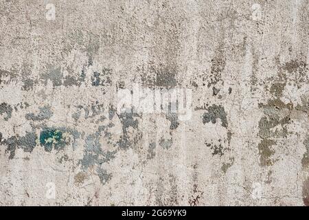 Old concrete plaster wall with worn peeling paint grunge background or texture Stock Photo