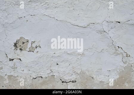 Old traditional whitewashed lime wall with peeling plaster, white grunge background or texture Stock Photo