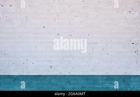 White painted brick wall with turquoise blue skirting board, grunge background or texture Stock Photo