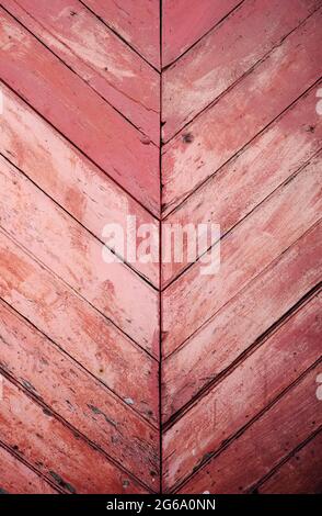 Old distressed pink wooden wall with diagonal strips, rustic background or texture Stock Photo