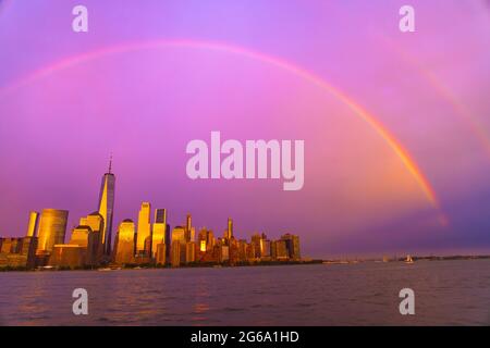 Rainbow Appears Over The Lower Manhattan Skyscraper NYC. Stock Photo