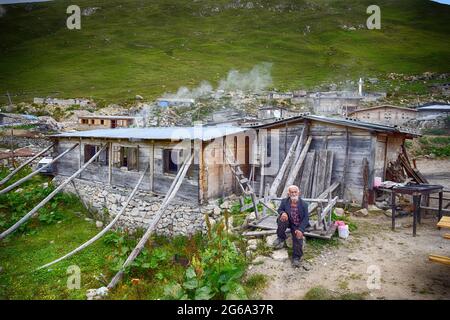 Avusor or Avusör is a plateau in the Çamlıhemşin district of Rize province. Old man sitting in front of his house in the plateau. Stock Photo