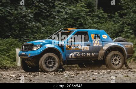 Action shot of rally car taking part in Raliul Moldovei on muddy forest roads Stock Photo