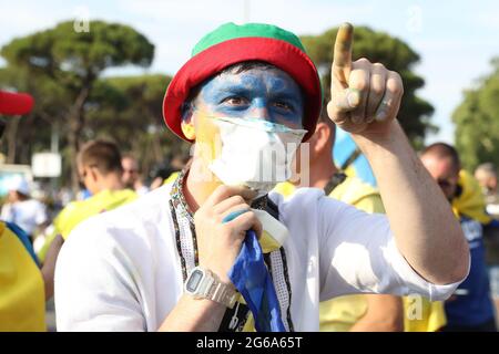 Rome, Italy, 3rd July 2021. A Ukraine fan with his face painted makes friendly gestures towards England fans prior to the UEFA Euro 2020 Quarter Final match at the Stadio Olimpico, Rome. Picture credit should read: Jonathan Moscrop / Sportimage Stock Photo