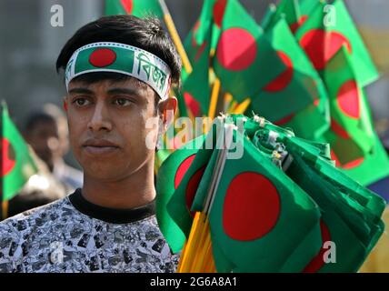 A vendor sells National flag  during 'Victory Day' celebrations at the National Memorial in Saver on the outskirts of Dhaka, Bangladesh. December 16, 2007. Stock Photo