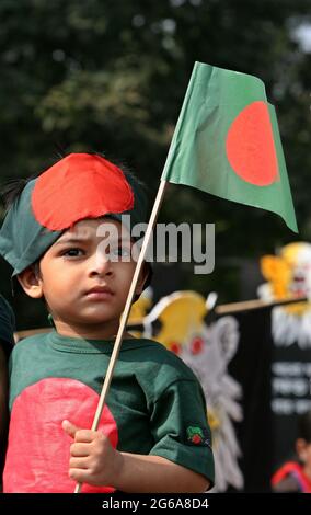 A Bangladeshi child holds national flag  during 'Victory Day' celebrations at the national memorial in Saver, on the outskirts of Dhaka, Bangladesh. On December 16, 1971 Bangladesh earned Independence from the Governing West Pakistan after a nine month long battle. Bangladesh. December 16, 2007. Stock Photo