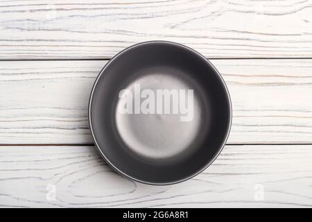 Black ceramic cup on white wooden table Stock Photo