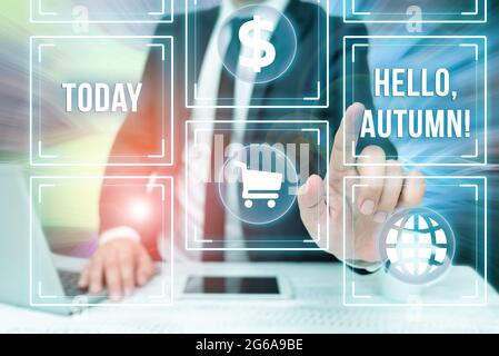 Hand writing sign Hello, Autumn. Business overview greeting used when embracing the change from summer to winter Bussiness Man Sitting Desk Laptop And Stock Photo