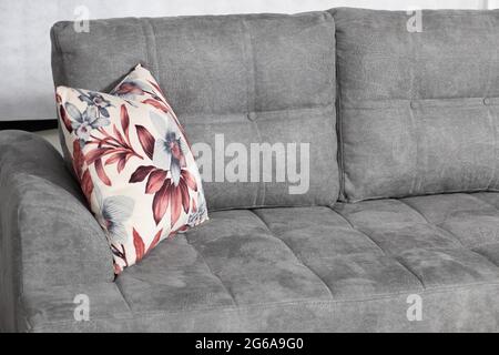 https://l450v.alamy.com/450v/2g6a9g0/a-closeup-shot-of-a-grey-modern-couch-with-a-pillow-in-a-room-2g6a9g0.jpg