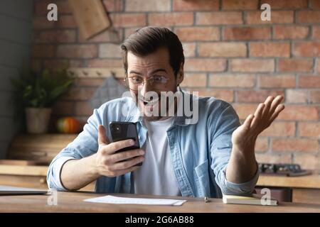 Excited happy man getting good surprising amazing news Stock Photo