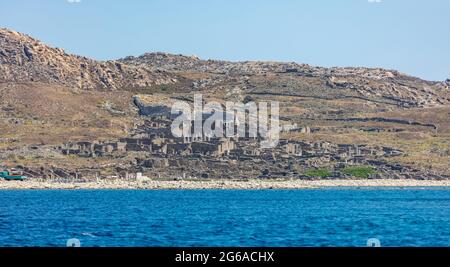Greece. Delos Cyclades island, general view from the sea. Archaeological site, UNESCO Heritage monument. Stone walls and marble pillars ruins on rocky Stock Photo