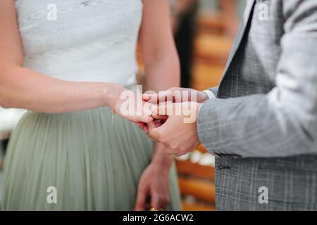 Bride and groom exchanging rings at their wedding close up. Stock Photo