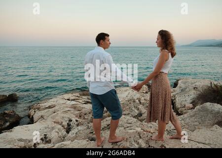 Couple on an evening seaside date Stock Photo