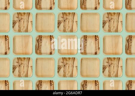 Eco-friendly palm leaf plates, isolated on green background. Plastic free, natural disposable and biodegradable tableware. Seamless repeating pattern. Stock Photo