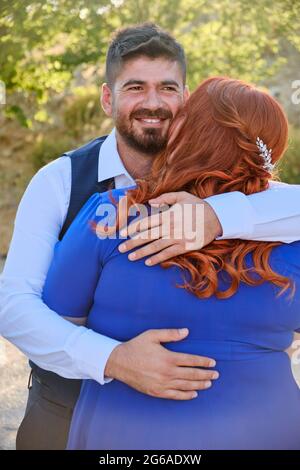 Man hugs his beloved woman smiling Stock Photo