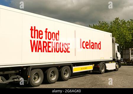 Swindon, England - June 2021: Refrigerated articulated lorry operated by the Iceland frozen foods company parked in a motorway service station Stock Photo