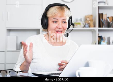 Mature woman communicates via the Internet Stock Photo