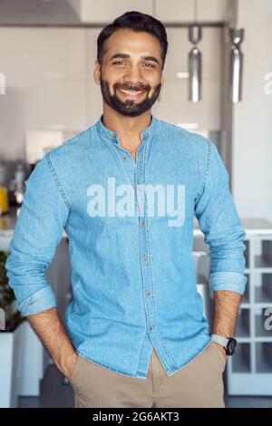 Portrait of young indian businessman freelancer looking t camera with smile Stock Photo