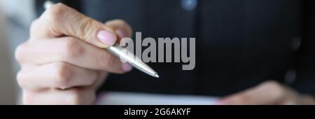Female hand makes notes with pen in notebook Stock Photo