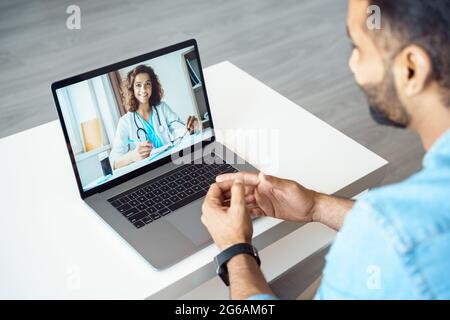 View over client shoulder sit at desk receive medical consultation online Stock Photo