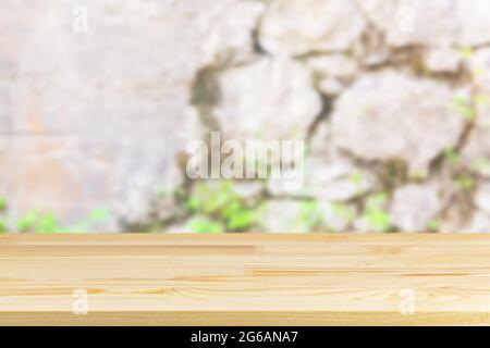 wood table top on blur stone wall background Stock Photo